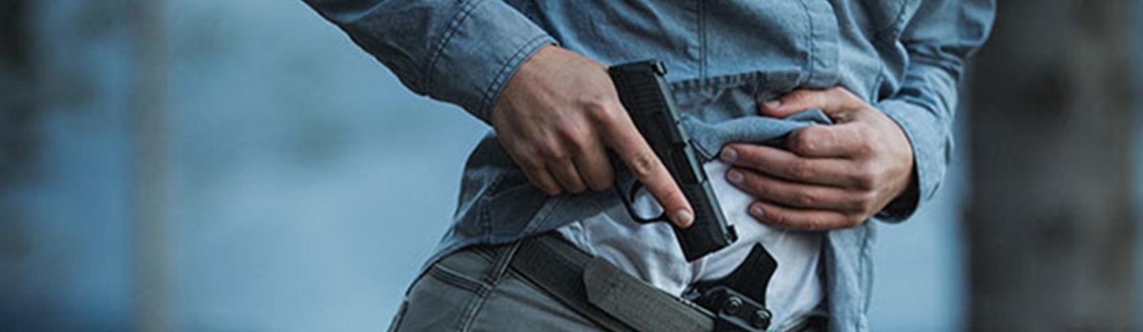 Male pulling out gun