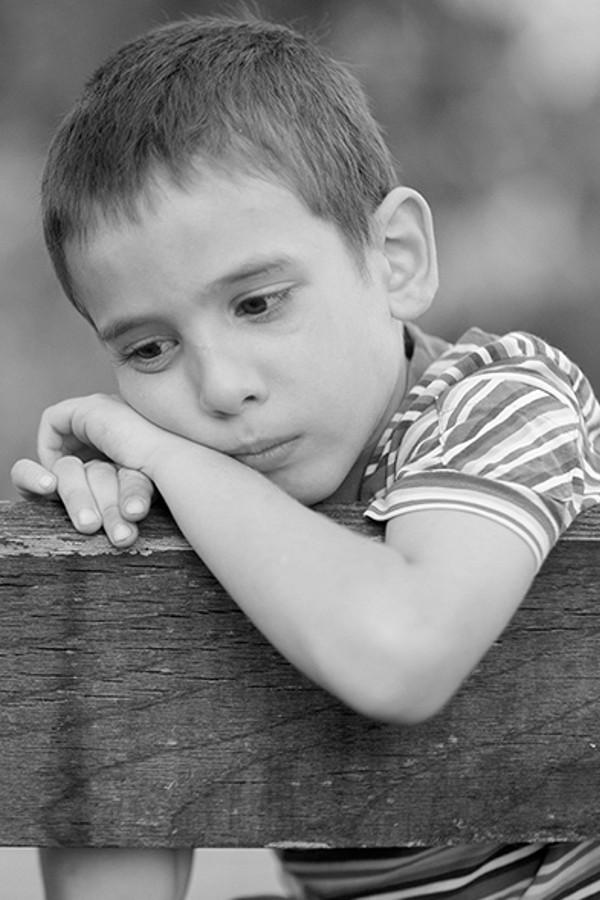 photo of a sad child in black & white