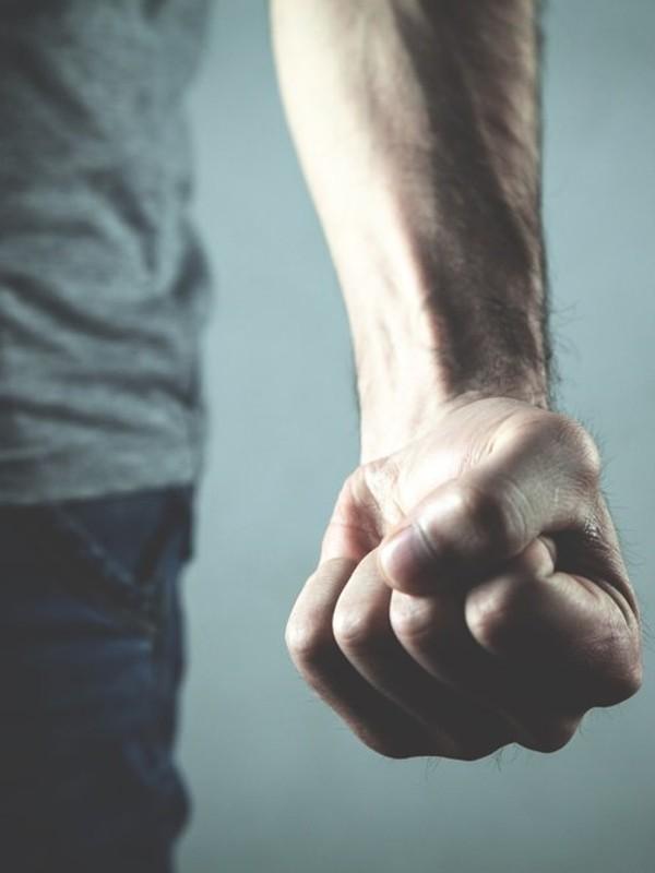 a person menacing doing a fist 