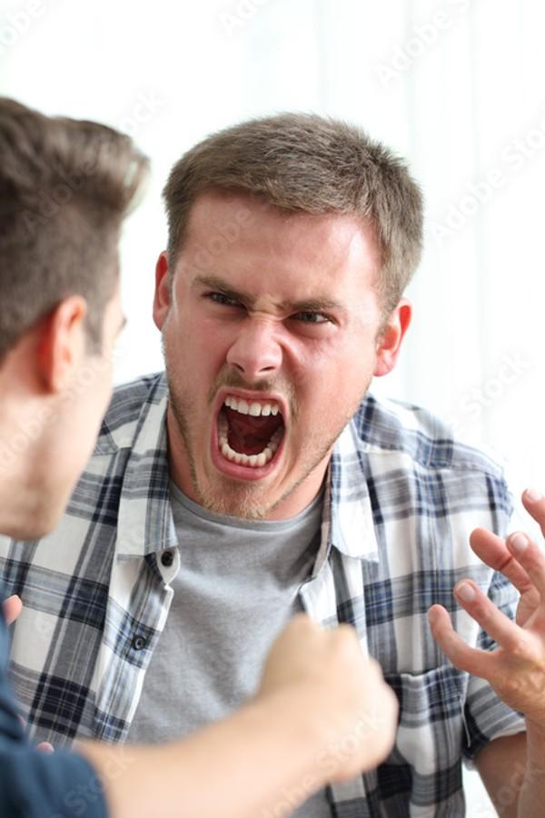 a young male screaming at another person